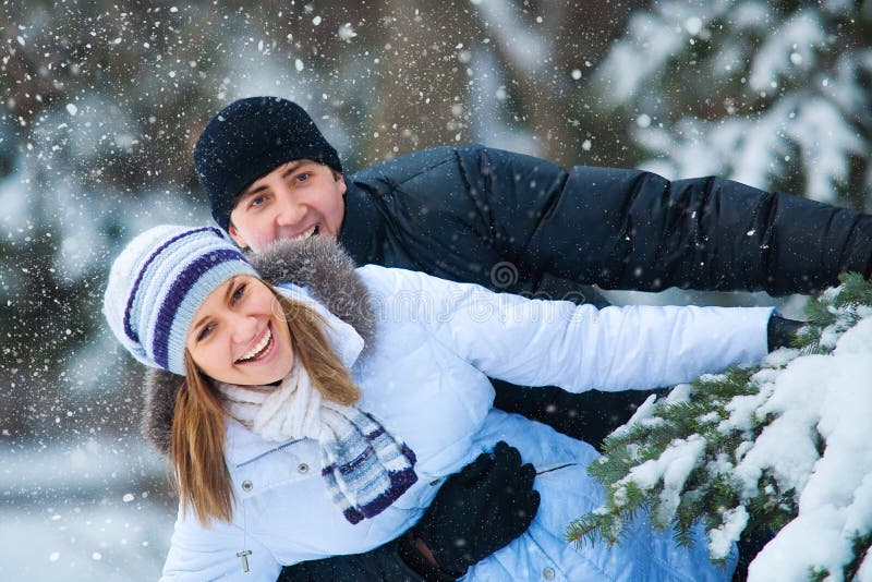 Young beautiful couple in winter park.