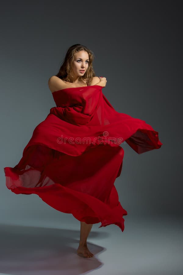 Young Beautiful Dancer in Red Dress Posing on a Dark Gray Studio ...