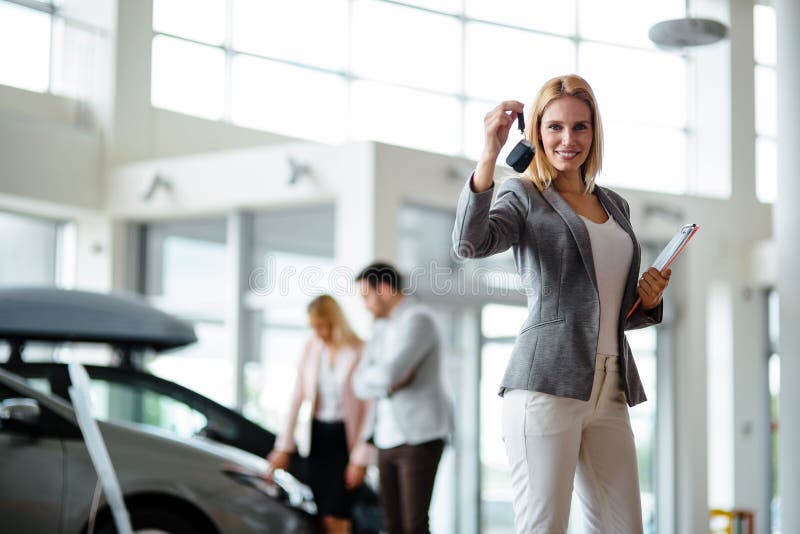 Young female car sales consultant working in showroom royalty free stock image Young female car sales consultant working in showroom royalty free stock image