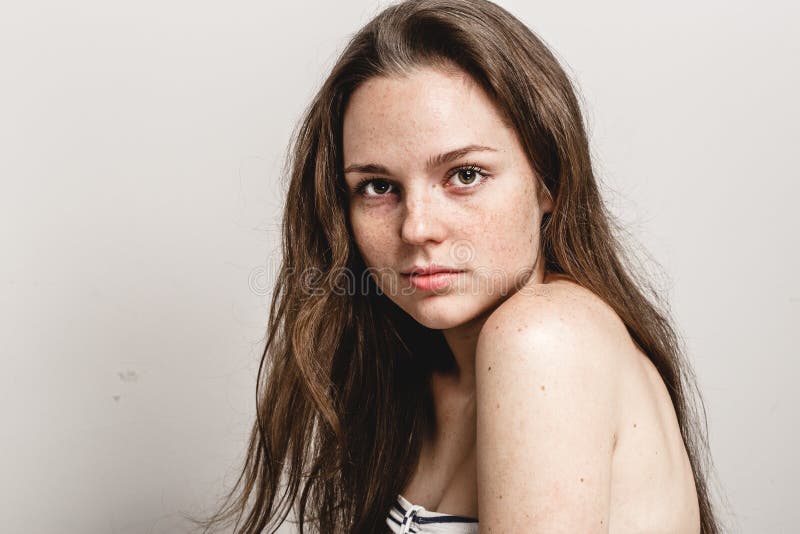 Young beautiful freckles woman face portrait with healthy skin royalty free stock photos