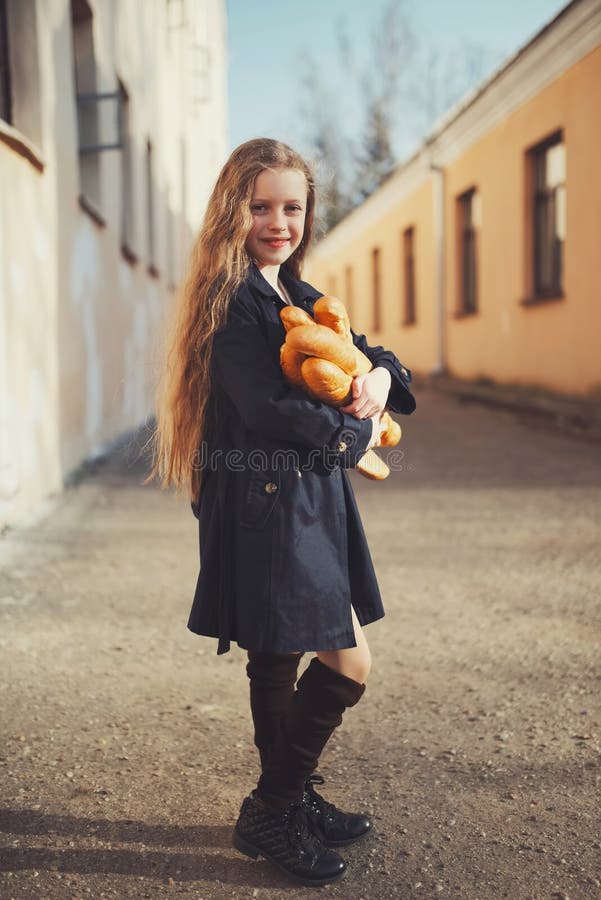 Young beautiful girl with baguette royalty free stock photography Young beautiful girl with baguette royalty free stock photography