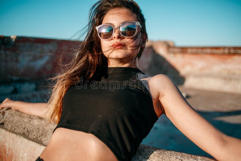 Young Beautiful Girl in Black Short Shorts and Black Top Posing on the ...