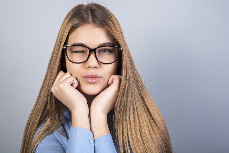 Young Beautiful Girl with Glasses Winks and Standing in Front of Grey  Background, a Lot of Clean Space Stock Image - Image of blonde, delight:  130330081