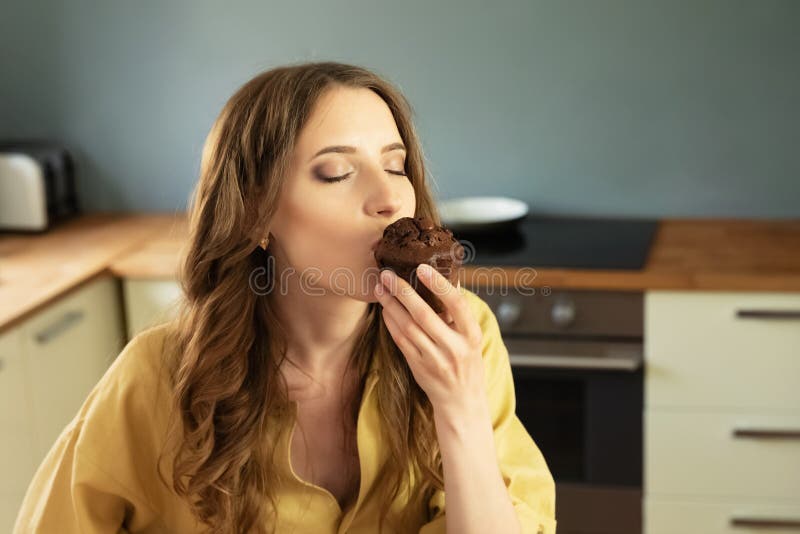Young beautiful girl having breakfast at home in the kitchen. royalty free stock photos Young beautiful girl having breakfast at home in the kitchen. royalty free stock photos