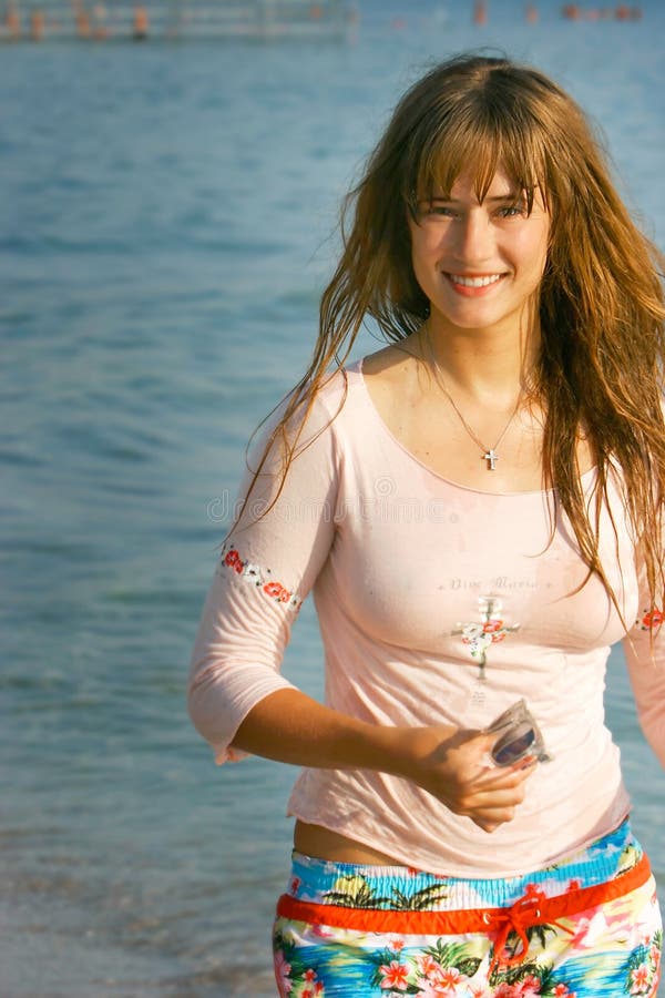 Young beautiful girl with long hair on sea