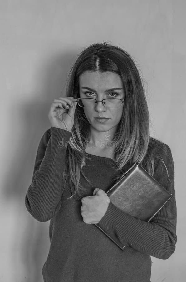 Young Beautiful Girl With Long Hair Teacher With Glasses With A Book In