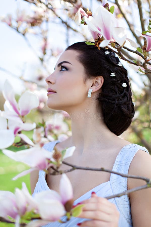 Young beautiful girl with magnolia