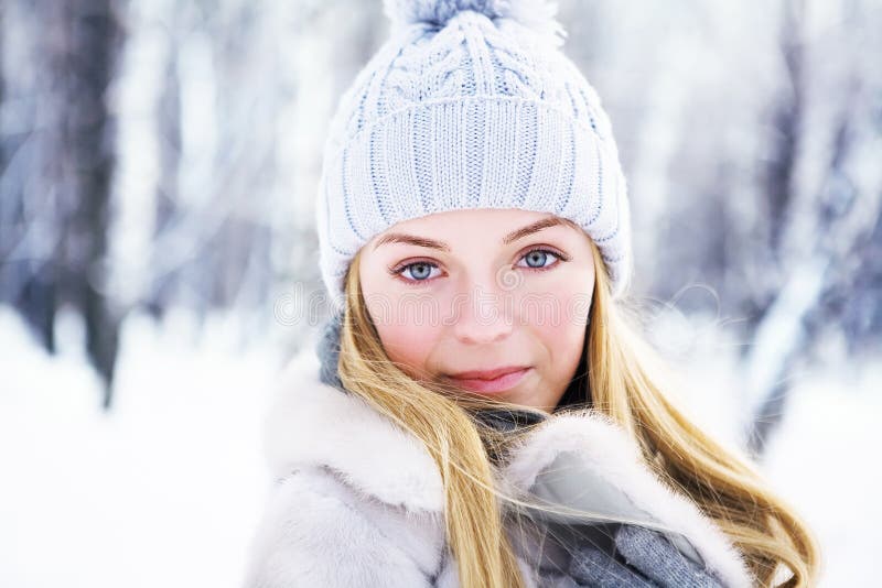 The young, beautiful girl, is photographed in the cold winter in park. Photoshoot in the winter in snow-covered park. The young beautiful girl with ideal skin royalty free stock image The young, beautiful girl, is photographed in the cold winter in park. Photoshoot in the winter in snow-covered park. The young beautiful girl with ideal skin royalty free stock image