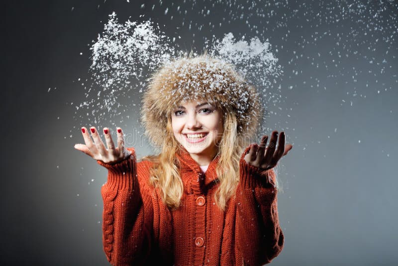 Young beautiful girl rejoices to snow