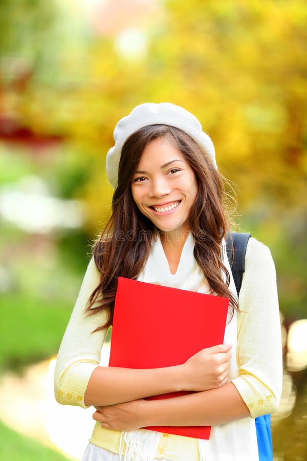 Young beautiful girl student in autumn park