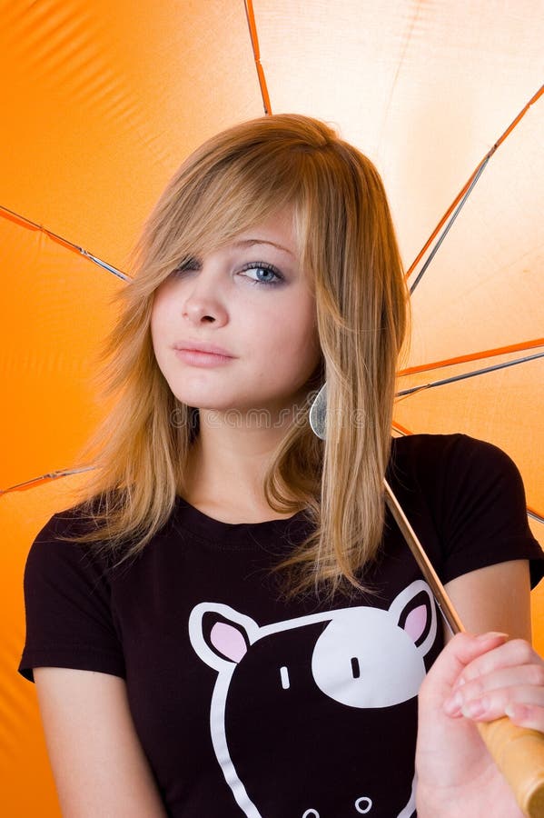 The young beautiful girl under umbrella