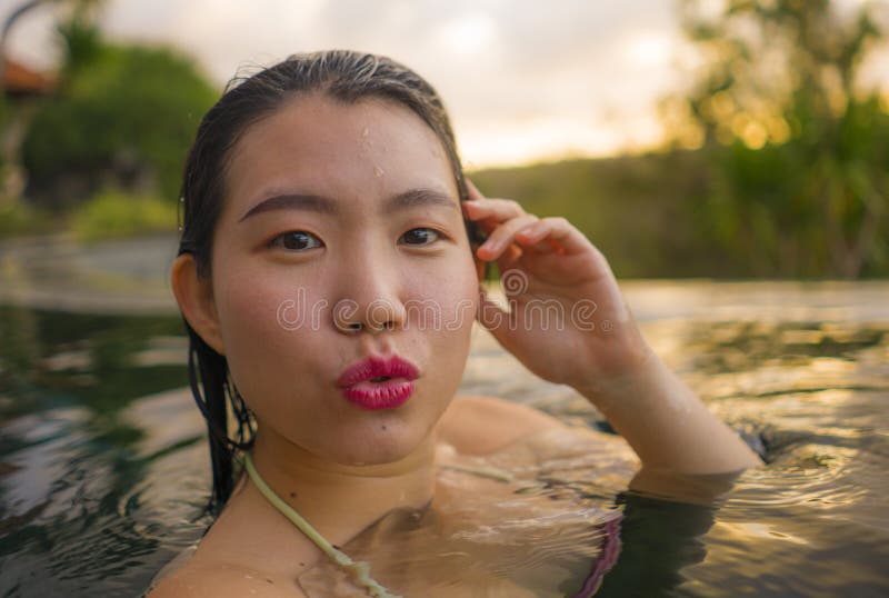 Young Beautiful And Happy Asian Chinese Woman In Bikini Enjoying Sunset 