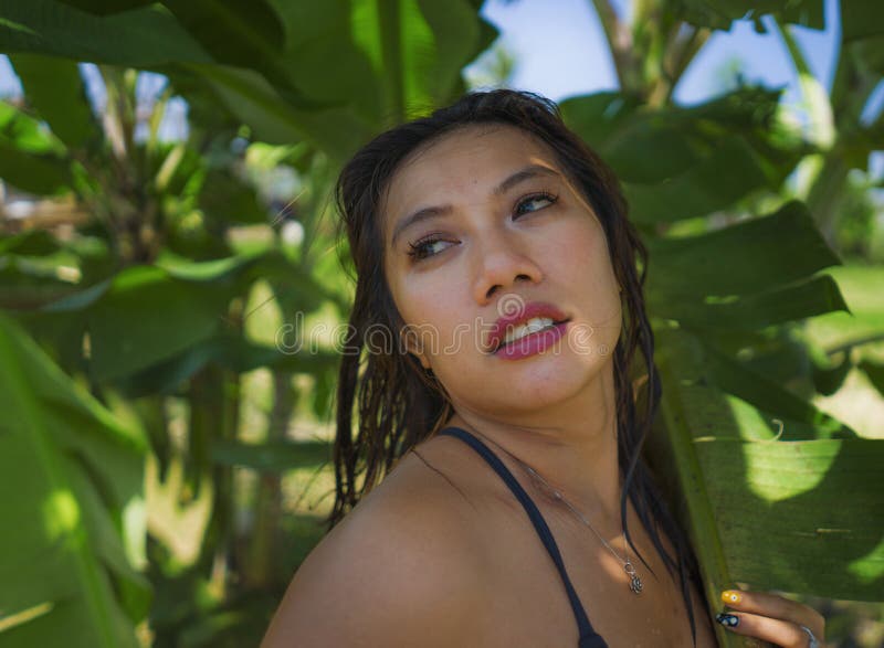 Young Beautiful And Happy Asian Indonesian Woman In Bikini Posing