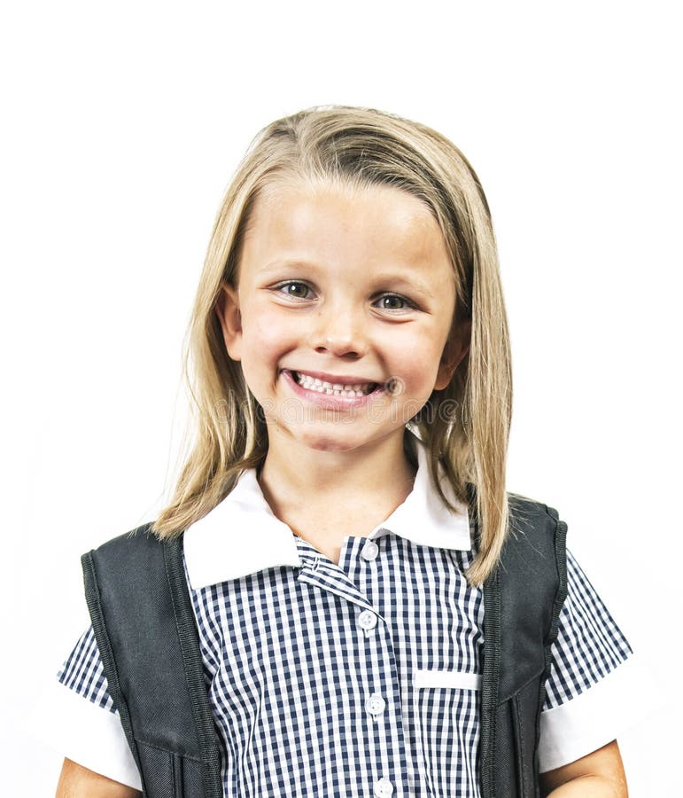 Young beautiful and happy child girl 6 to 8 years old blond hair and blue eyes smiling excited wearing school uniform and backpack