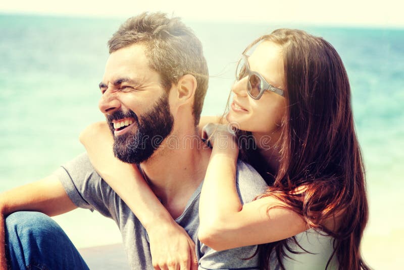 Young beautiful happy couple in love tenderly embracing against the background of the sea, love honeymoon Valentine`s Day concept royalty free stock photography Young beautiful happy couple in love tenderly embracing against the background of the sea, love honeymoon Valentine`s Day concept royalty free stock photography