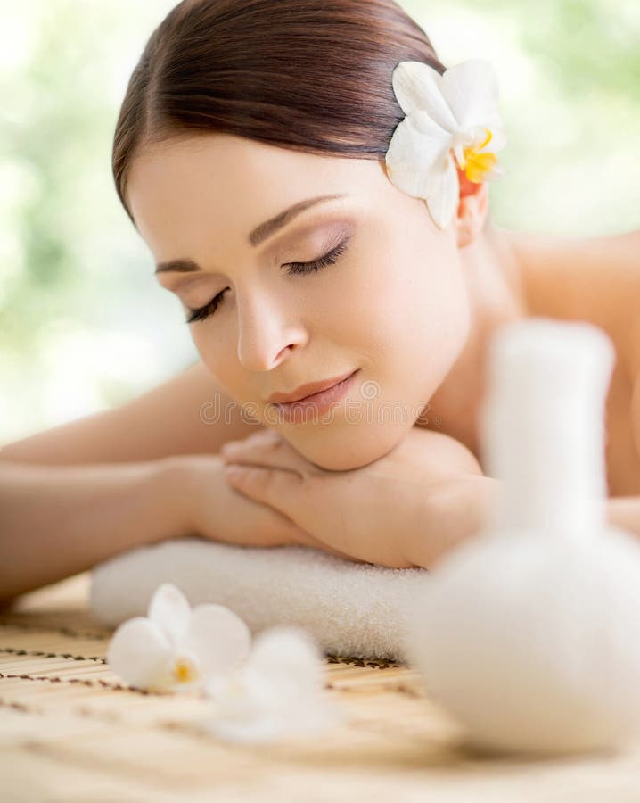 Young And Beautiful Girl Relaxing In Spa Salon Massage Therapy Over