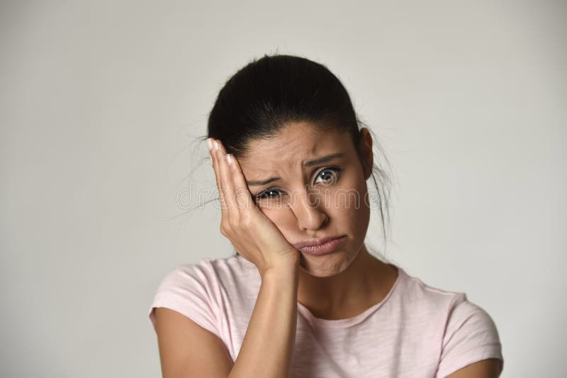 Young beautiful hispanic sad woman serious and concerned in worried depressed facial expression