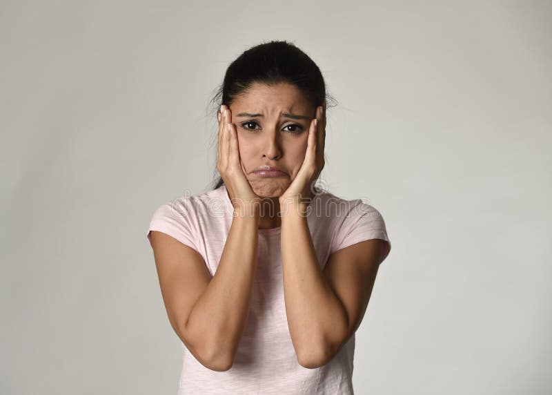 Young beautiful hispanic sad woman serious and concerned in worried depressed facial expression