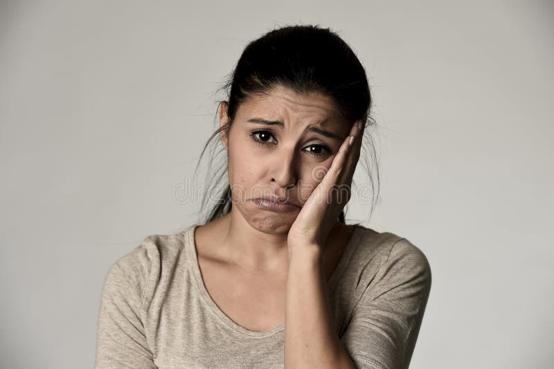 Young beautiful hispanic sad woman serious and concerned in worried depressed facial expression