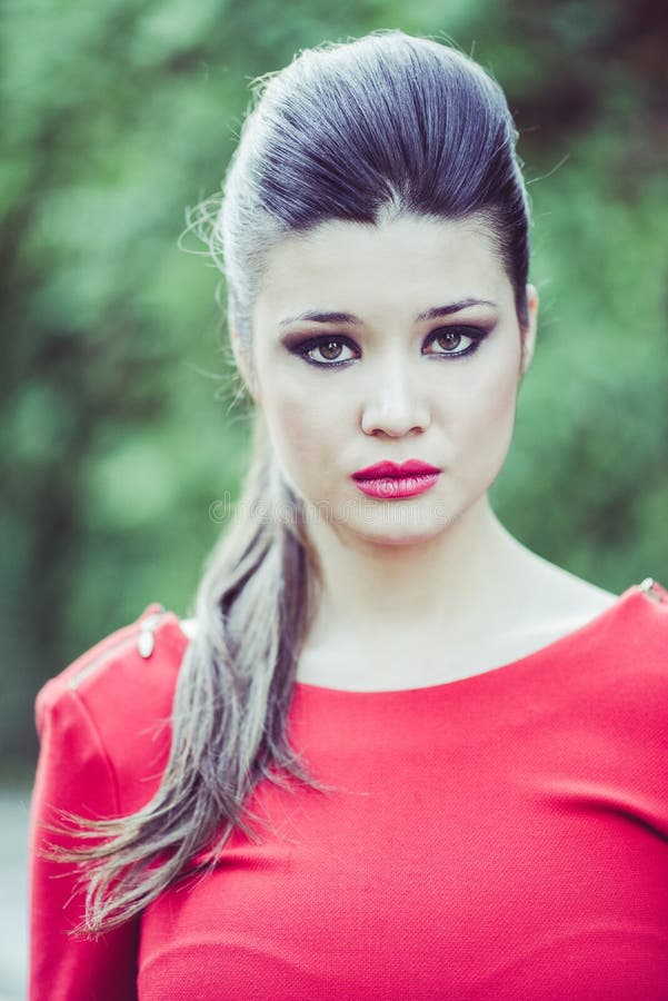 Young beautiful japanese woman with red dress