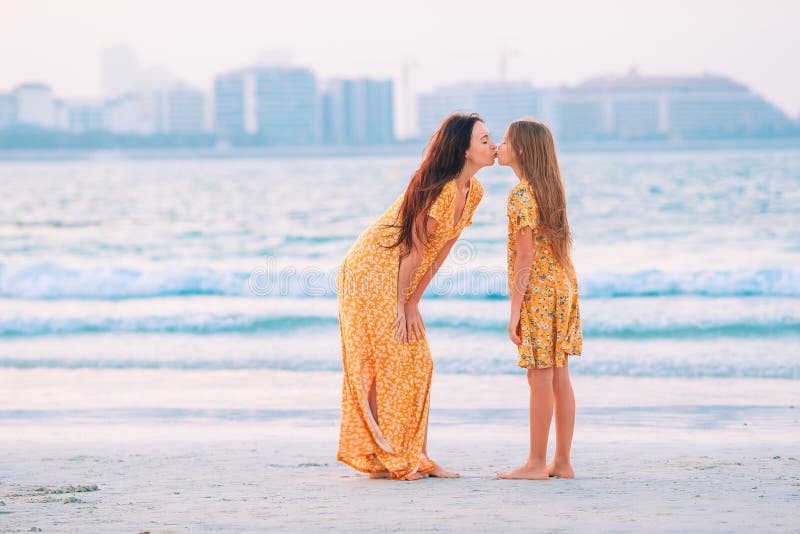 Beautiful Mother And Daughter At The Beach Enjoying Summer Vacation 