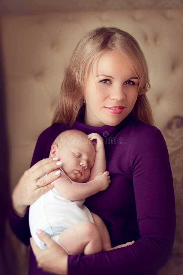 Young Beautiful Mother Holding Sleeping Newborn Baby On Hands In Stock
