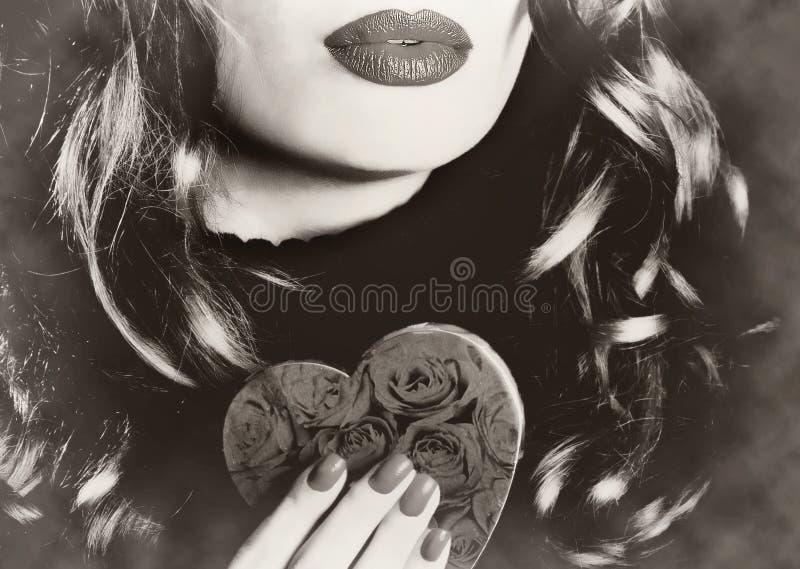 Young beautiful pretty woman holding a heart makeup valentine love romance sepia vintage retro