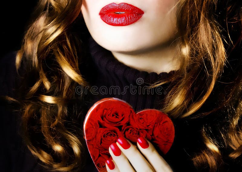 Young beautiful pretty woman holding a red heart makeup valentine love romance