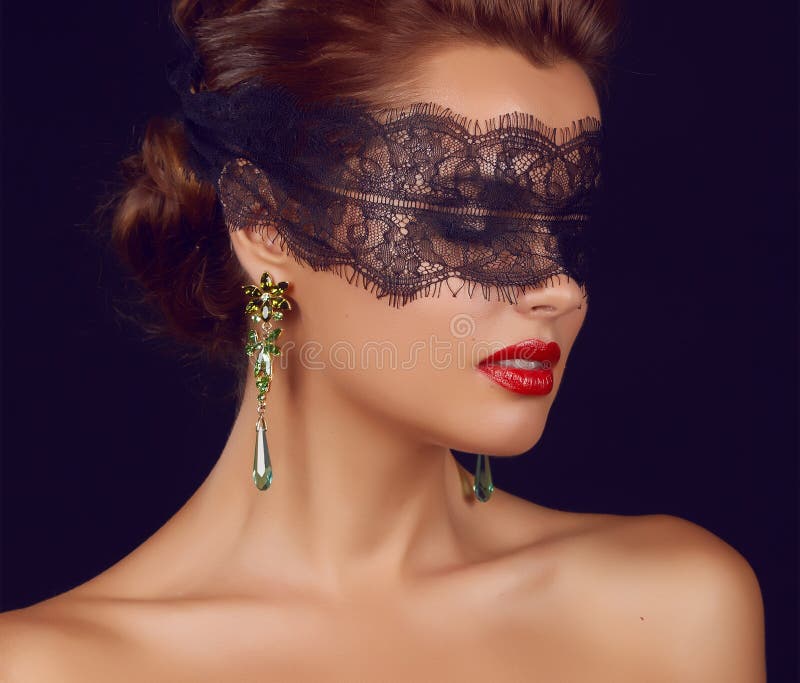 Young beautiful woman with dark lace on eyes bare shoulders and neck, jewelry earrings, feeling temptation, passion sex red l