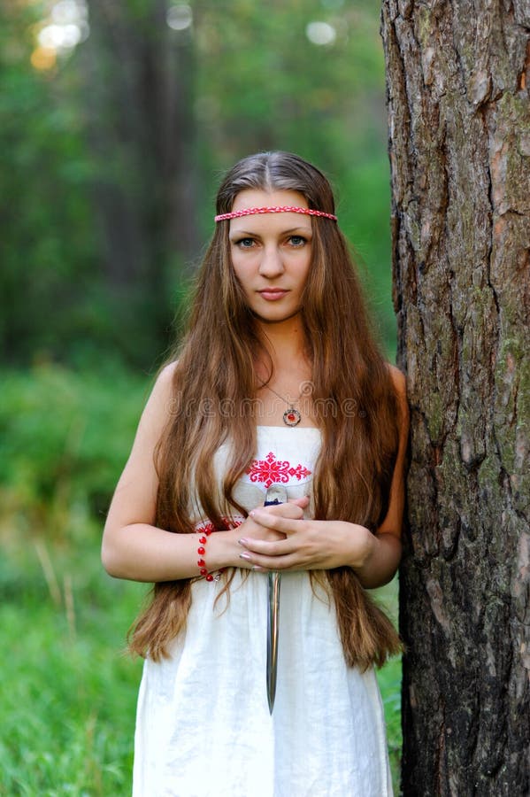 young beautiful slavic girl long hair ethnic attire stands summer forest brilliant ritual dagger her hands dress 106910333