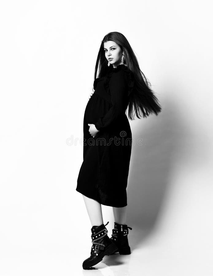 Young Beautiful Slim Pregnant Woman With Long Hair In Black Long Dress. Pregnancy Fashion Look