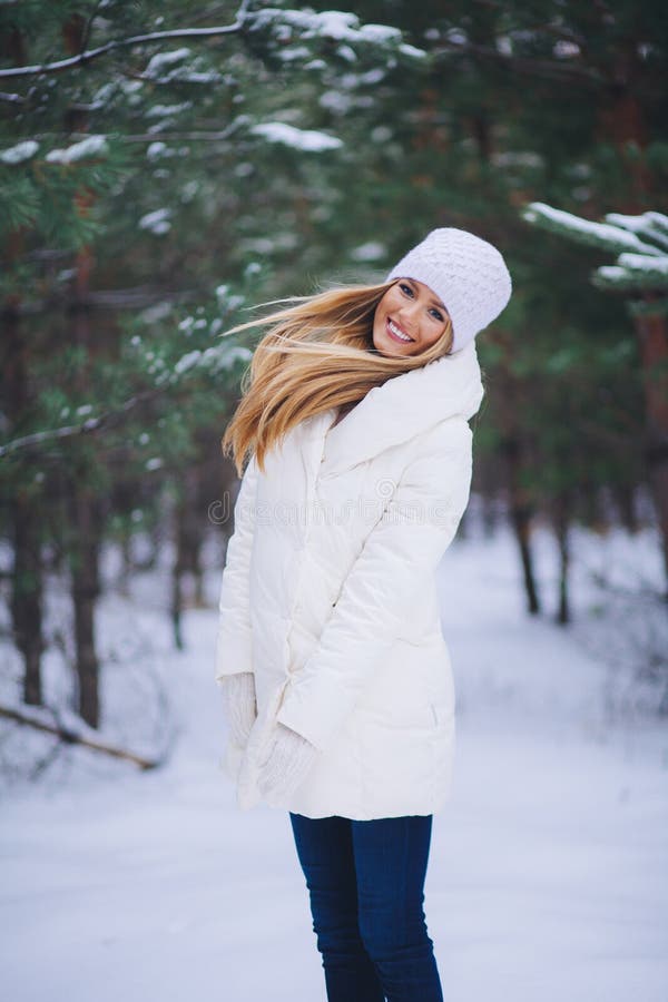 Young beautiful smiling girl portrait in winter forest