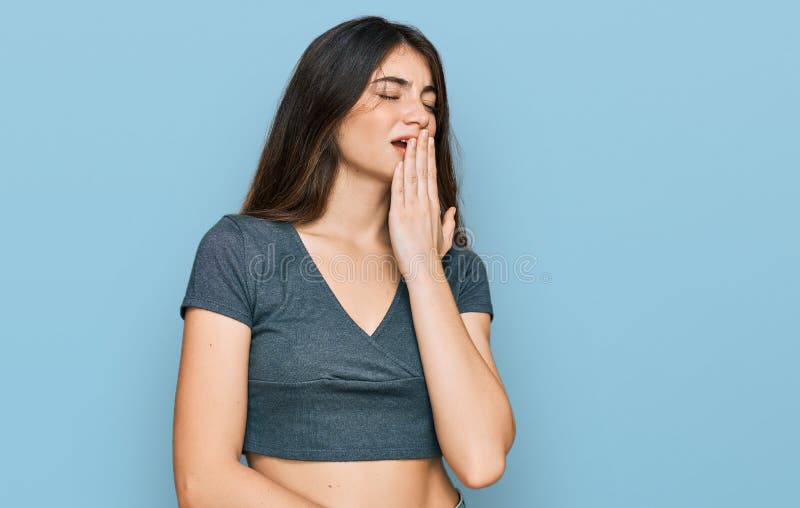 Tight cropped face of a scared young girl with hands covering