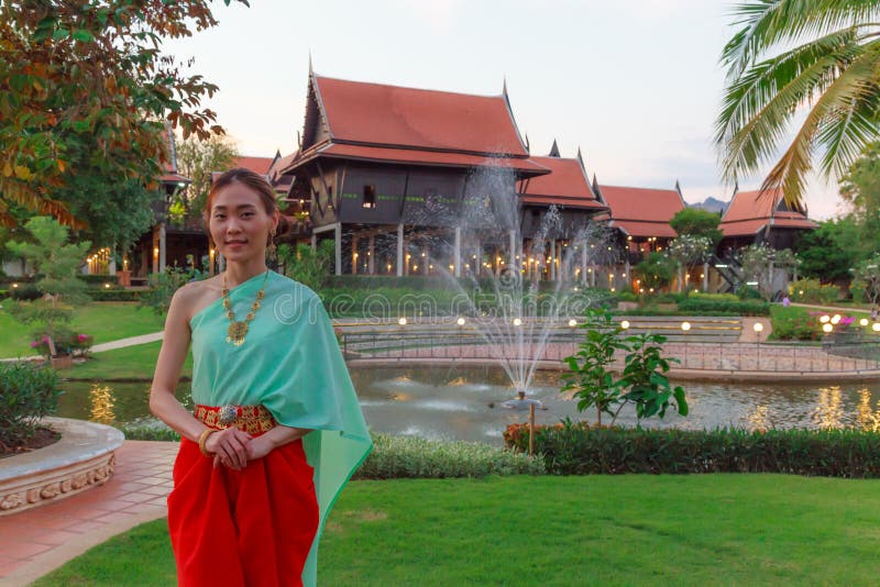 Young Beautiful Thai Asian woman dressing in vintage retro Traditional Thai costume in wait to welcome guest. Thailand Cultural stock photos Young Beautiful Thai Asian woman dressing in vintage retro Traditional Thai costume in wait to welcome guest. Thailand Cultural stock photos