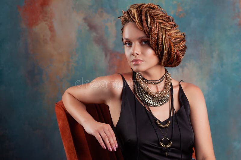 Young beautiful woman with afro braids. Ethnic style, hairstyle with weaving. Tanned attractive girl