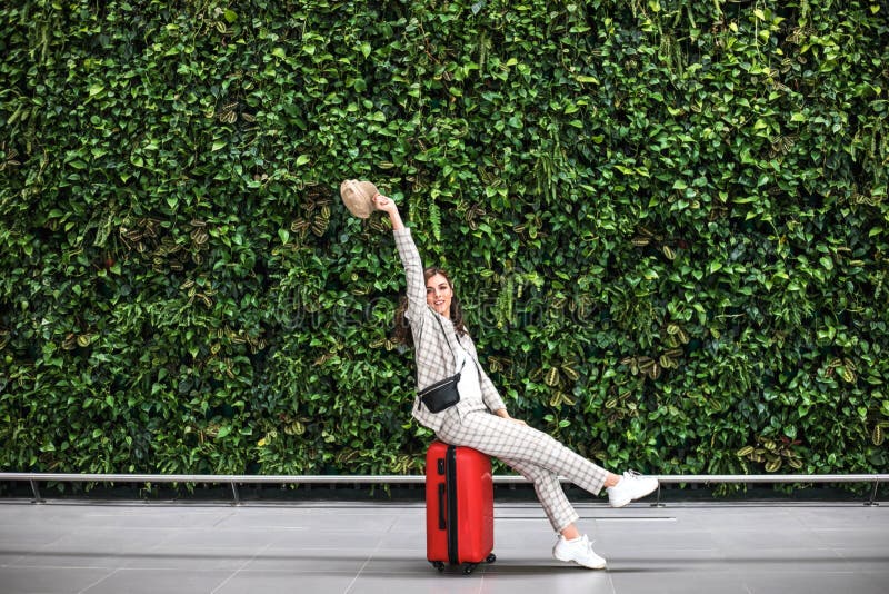Young beautiful woman in Airport against green wall. royalty free stock photography Young beautiful woman in Airport against green wall. royalty free stock photography