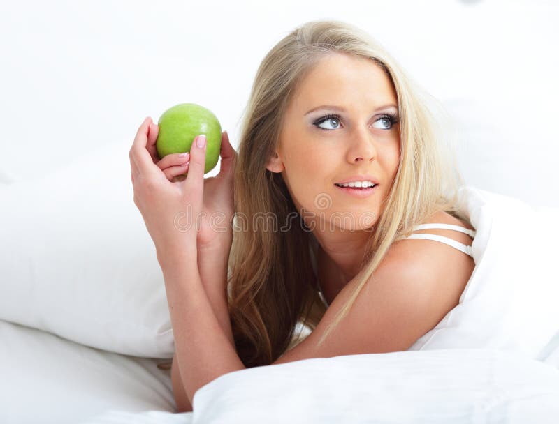 Young beautiful woman with apple stock photo