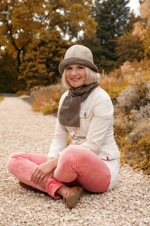 Young beautiful woman in autumn park