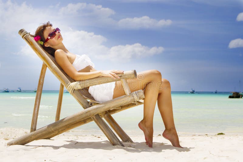 Young beautiful woman in bikini on sea background