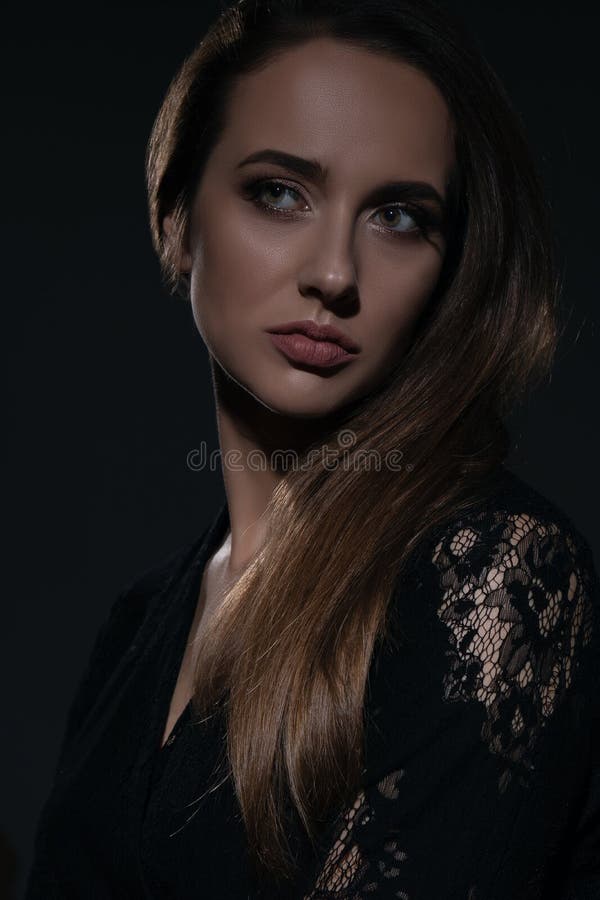 Young Beautiful Woman in Black Dress Shot in the Studio in the Shadows ...