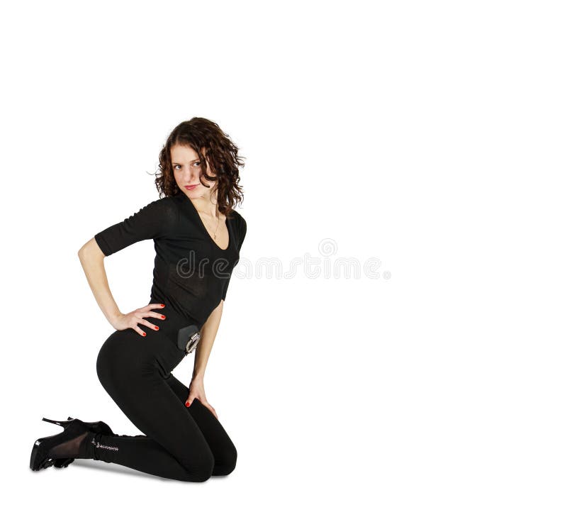 Young beautiful woman in black suit posing crouching