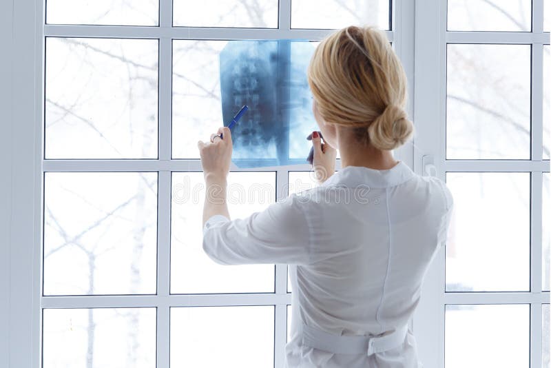 Young beautiful woman doctor with stethoscope and x-ray.