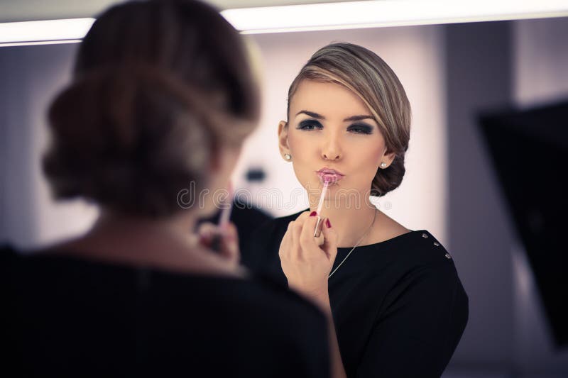 Young beautiful woman does a house make up royalty free stock image Young beautiful woman does a house make up royalty free stock image