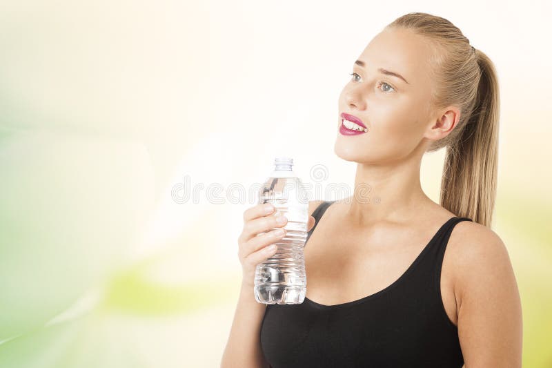 A young beautiful woman drinking from a bottle of water stock images A young beautiful woman drinking from a bottle of water stock images
