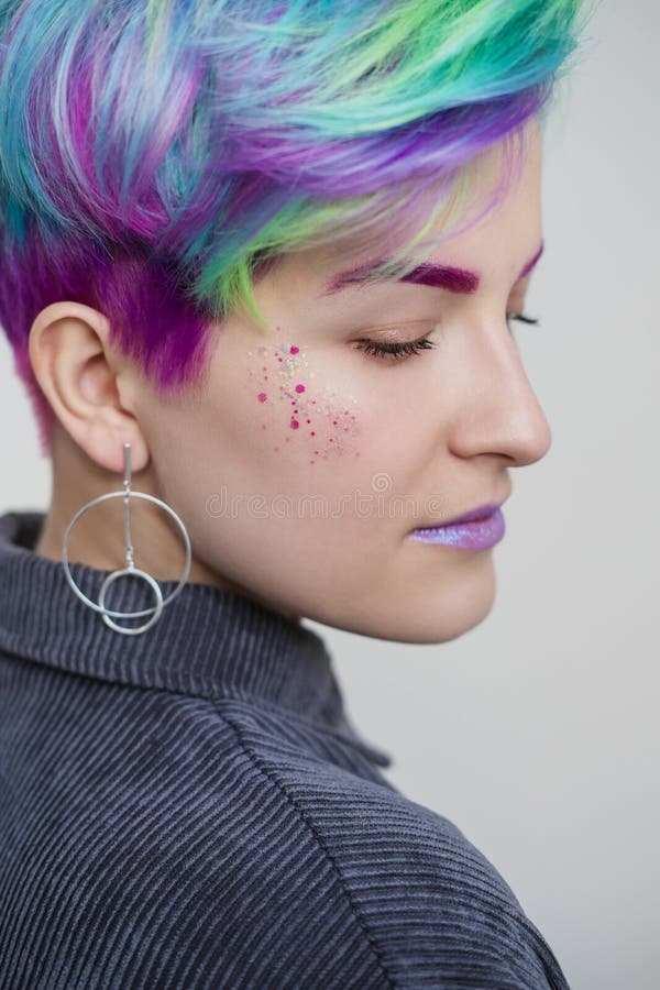 Young beautiful woman with dyed blue and green hair. Pixie bob short haircut The concept of hair styling. royalty free stock images Young beautiful woman with dyed blue and green hair. Pixie bob short haircut The concept of hair styling. royalty free stock images