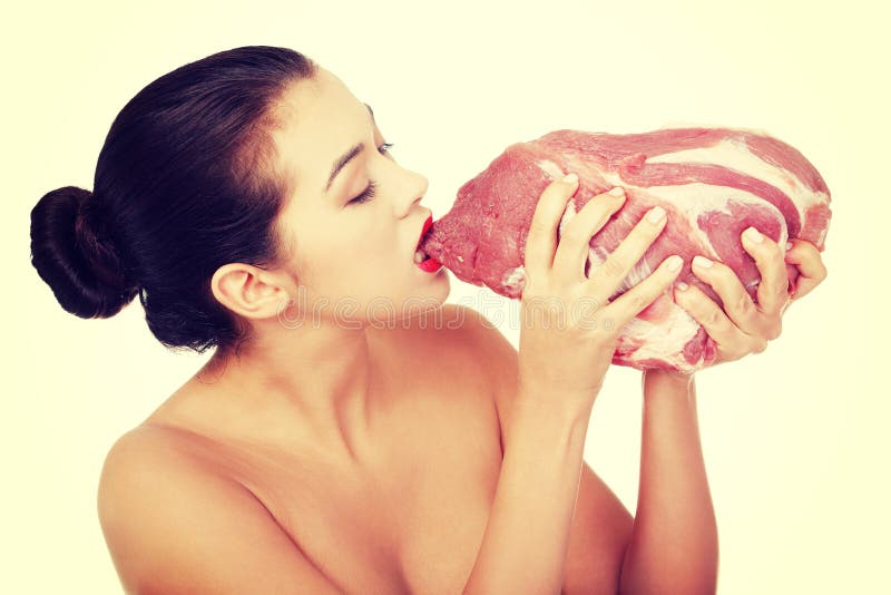 Young beautiful woman eating raw meat. 