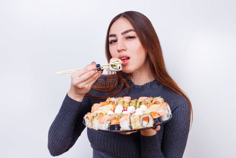Young Beautiful Woman Enjoy Eating Sushi, Studio Shoot on White Stock ...