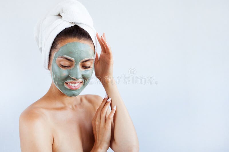 Young beautiful woman in face mask of therapeutic blue mud. Spa stock photo Young beautiful woman in face mask of therapeutic blue mud. Spa stock photo