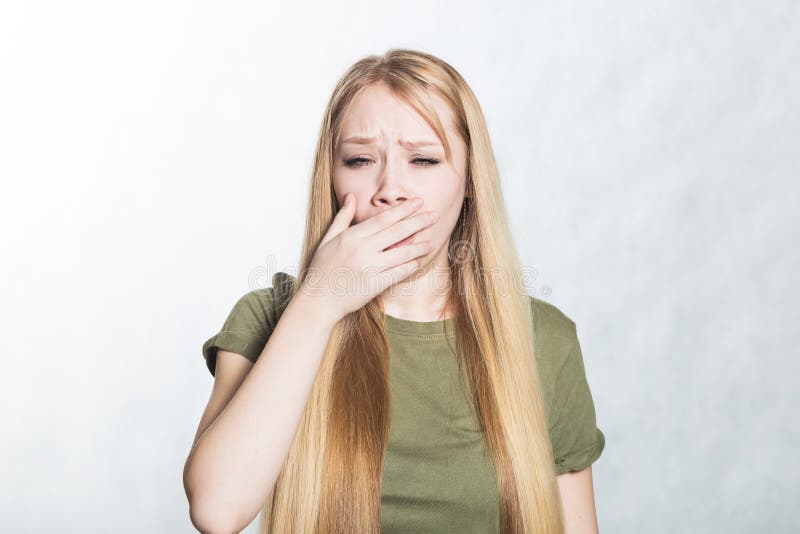 Young beautiful woman feeling tired and yawns. royalty free stock images Young beautiful woman feeling tired and yawns. royalty free stock images