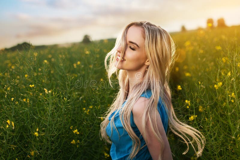 Young beautiful woman in the fields stock photo Young beautiful woman in the fields stock photo